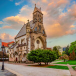 Amazing view of Freedom square and historical St. Michael chapel in center of Kosice, Slovakia at spring evening. Picturesque sunset burning sky